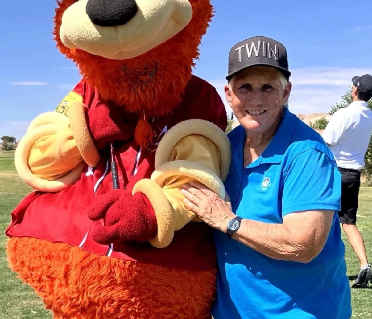 Sandy Lemon poses with Orbit, the Albuquerque Isotopes mascot.